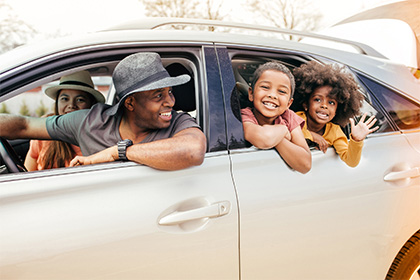 A happy family travelling together in car
