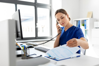 Nurse talking over the phone at hospital