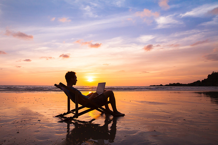 Trade Your Desk for the Beach? The Rise of the “Workcation” and How It Can Affect Your Team