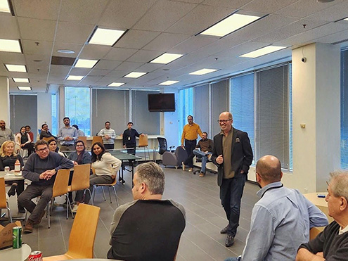 Shot of president and CEO of SEB Inc. John McKimm giving a welcome speech to employees for back to office